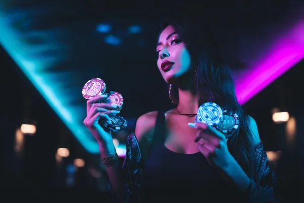 JETA90 App — Enjoy seamless gaming on your smartphone A young woman relaxing with her phone while dynamic casino elements float around her, illustrating the smooth mobile experience offered by the JETA90 app.