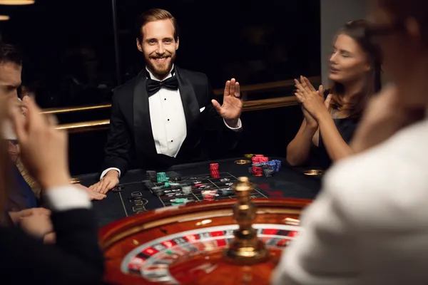 A confident dealer surrounded by casino chips inviting players to access their JETA90 account, reflecting quick and easy login options.